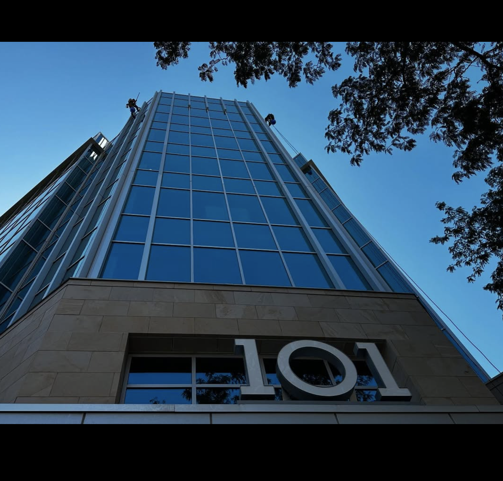 Half Full crew rappelling 101 Tower in downtown SLC