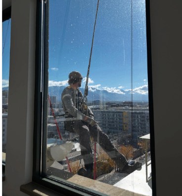 Spotless mirror-finish window reflecting the city skyline