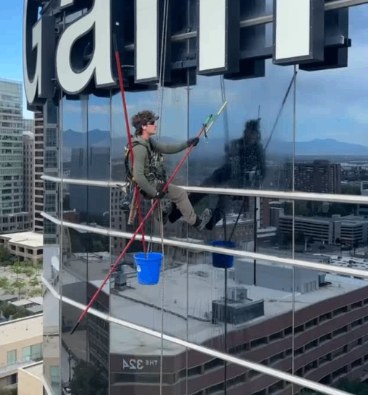 Window cleaner working high above downtown Salt Lake City